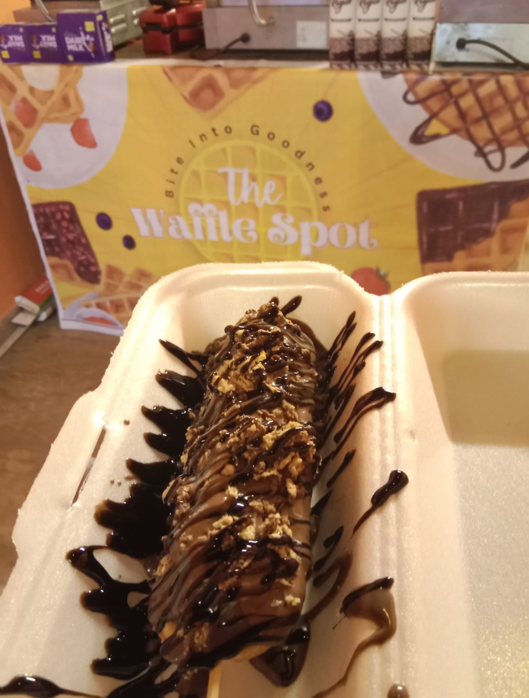 Lollipop waffle coated in chocolate with crushed biscuit topping