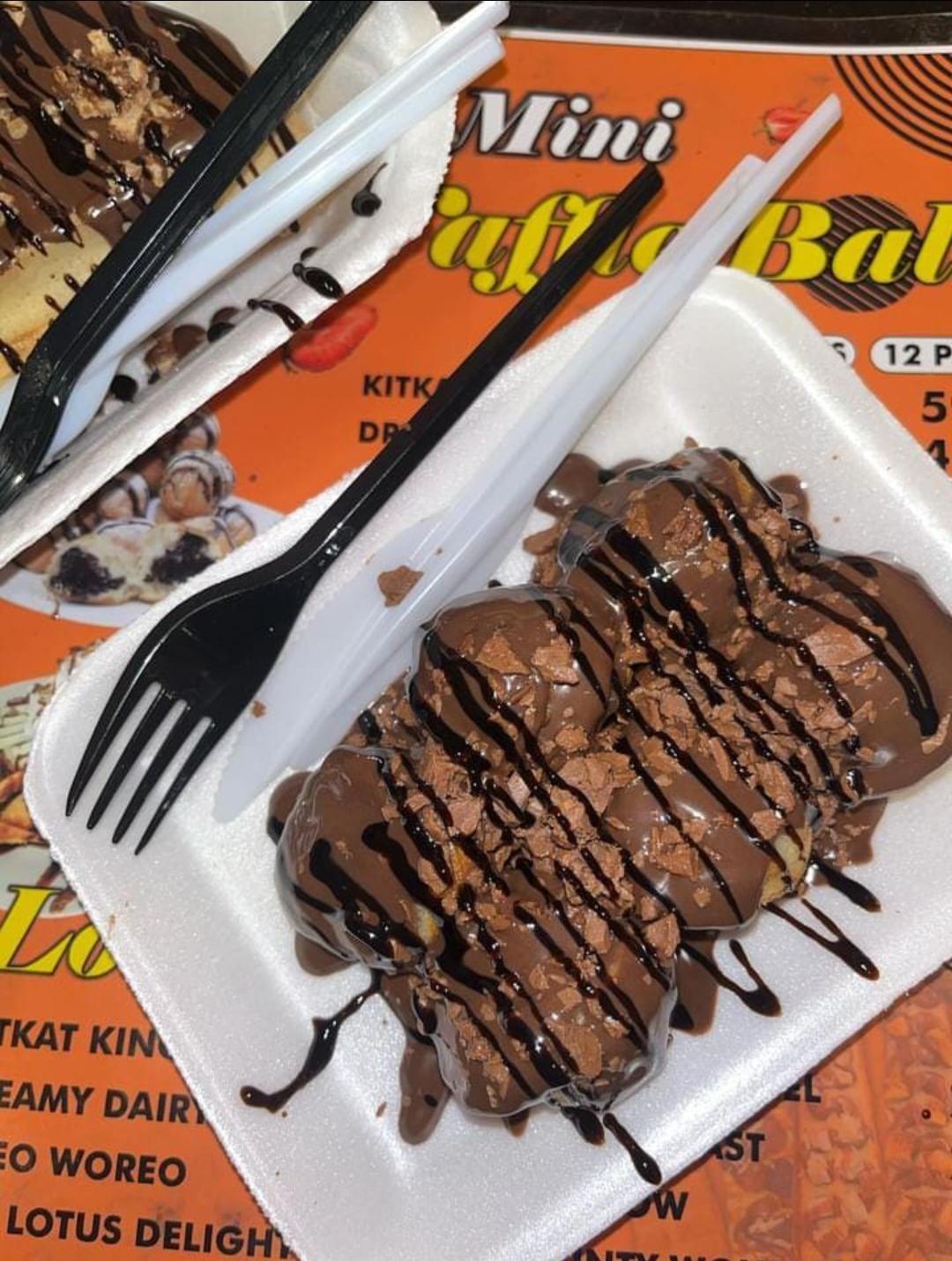 Mini waffle balls covered in milk chocolate and flakes
